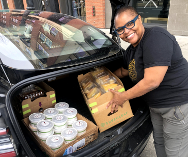 Tanya Holland of Brown Sugar Kitchen packs up food deliveries Photo courtesy of East Bay FeedER